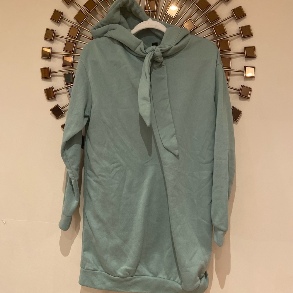 green sweatshirt.